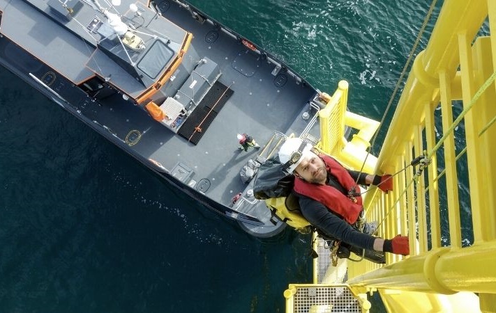 person climbing offshore platform