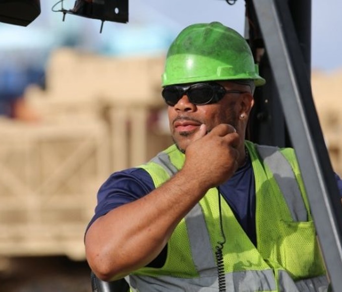 worker on a forklift using a radio