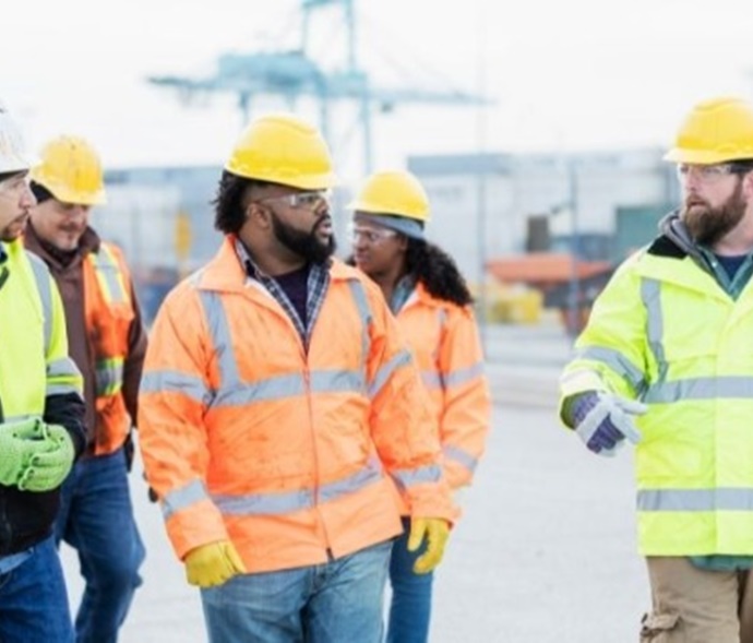 Group of workers walking across a cargo facility