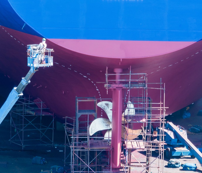 Painters painting a ship